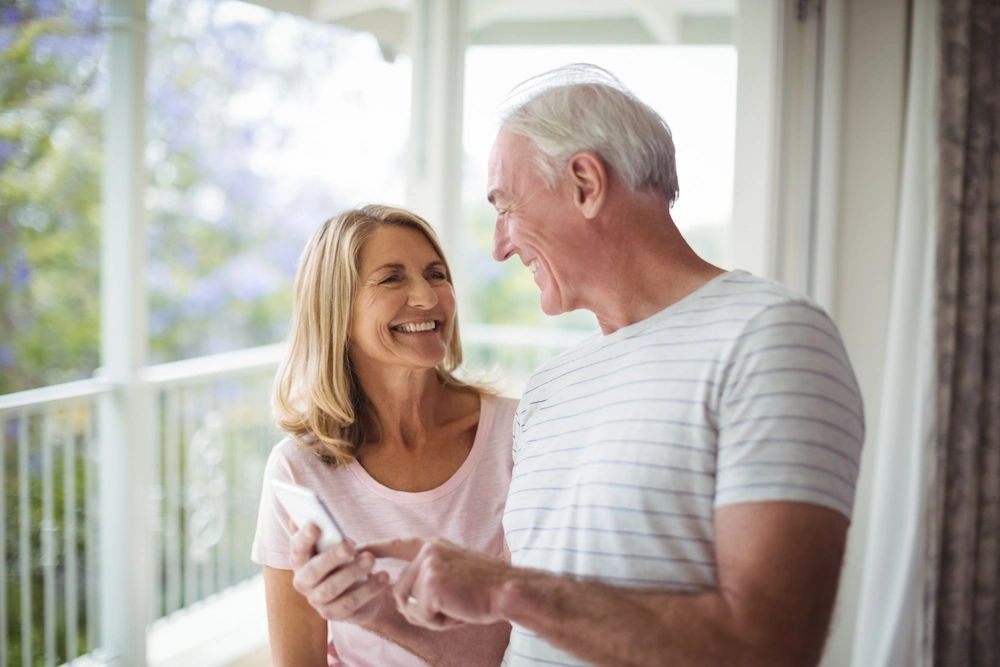 happy-senior-couple-interacting-with-each-other-balcony